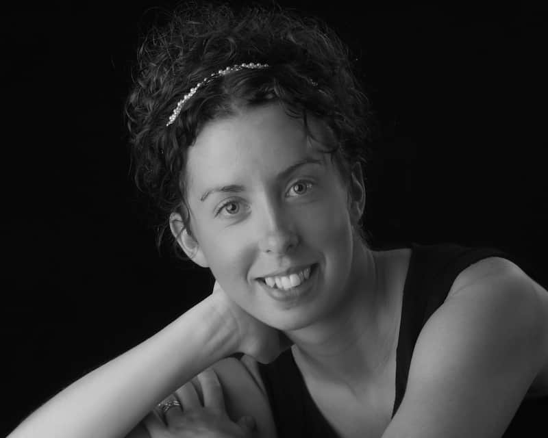 A picture of Kari Peters, the content creator of Get Inspired Everyday. The image is black and white with a woman in a black dress leaning her head on her hand.
