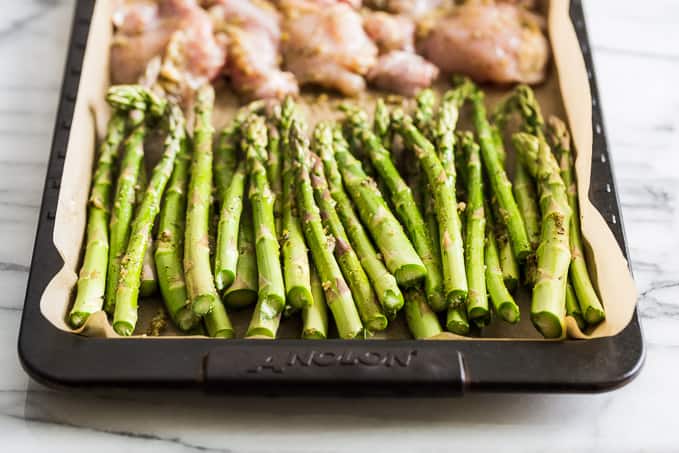Chicken and asparagus, prepped and ready to be cooked sheet pan style!