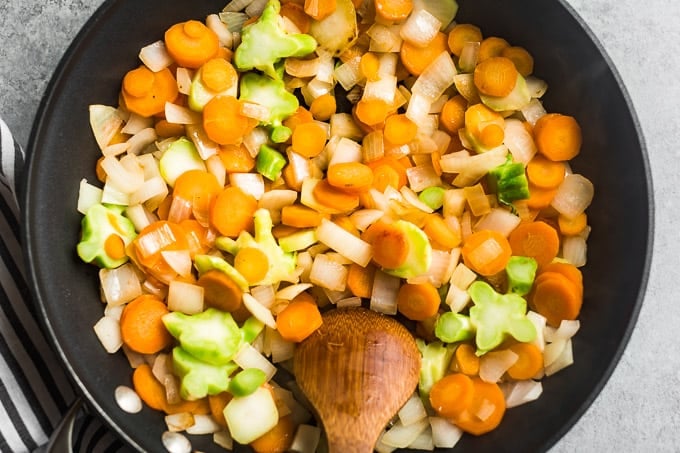 Sautéing the veggies in a large skillet.