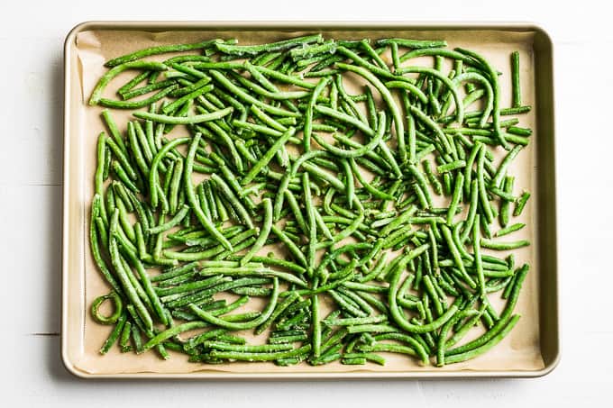 Green beans prepped with garlic powder and olive oil on a sheet pan!