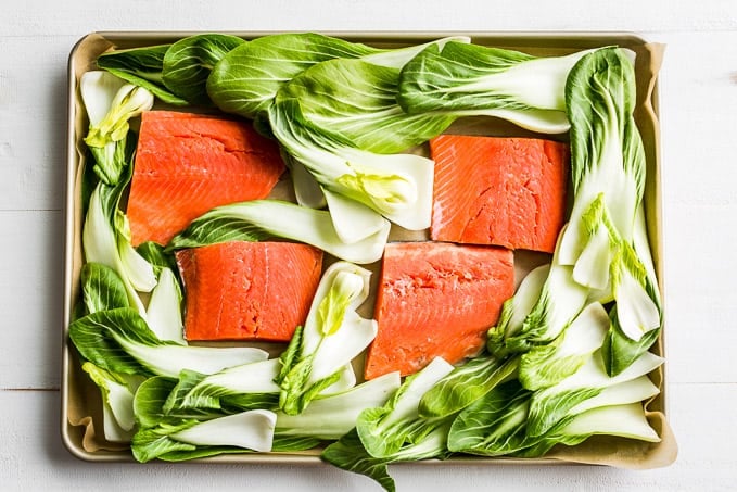 Salmon and veggies arranged on a sheet pan for roasting!