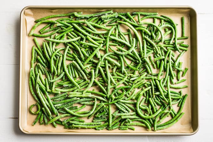Prepped green beans on a sheet pan to be roasted!