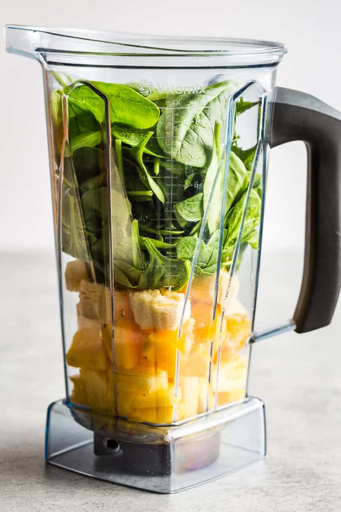 Ingredients for the green smoothie layered into the blender!