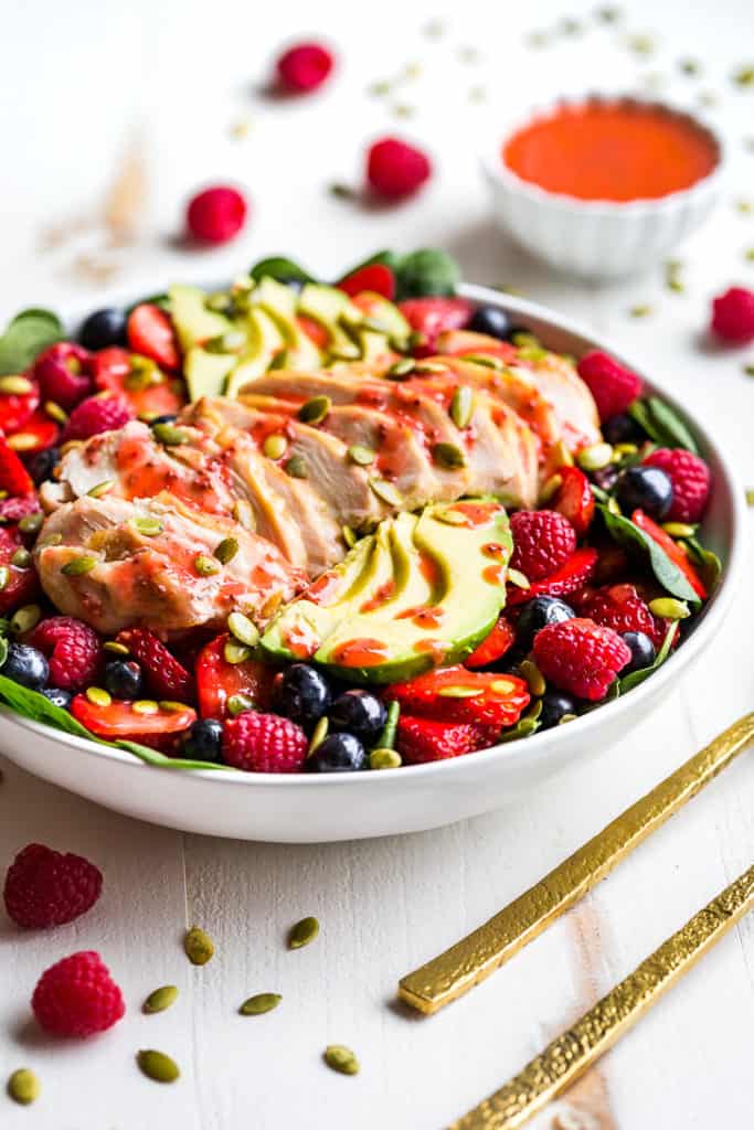 Triple Berry Spinach Salad topped with grilled chicken and avocado!