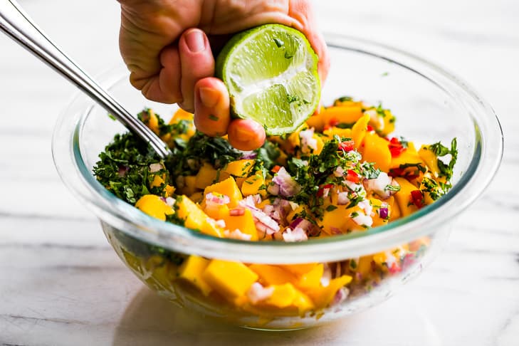 Mixing together the mango salsa for the fish tacos!