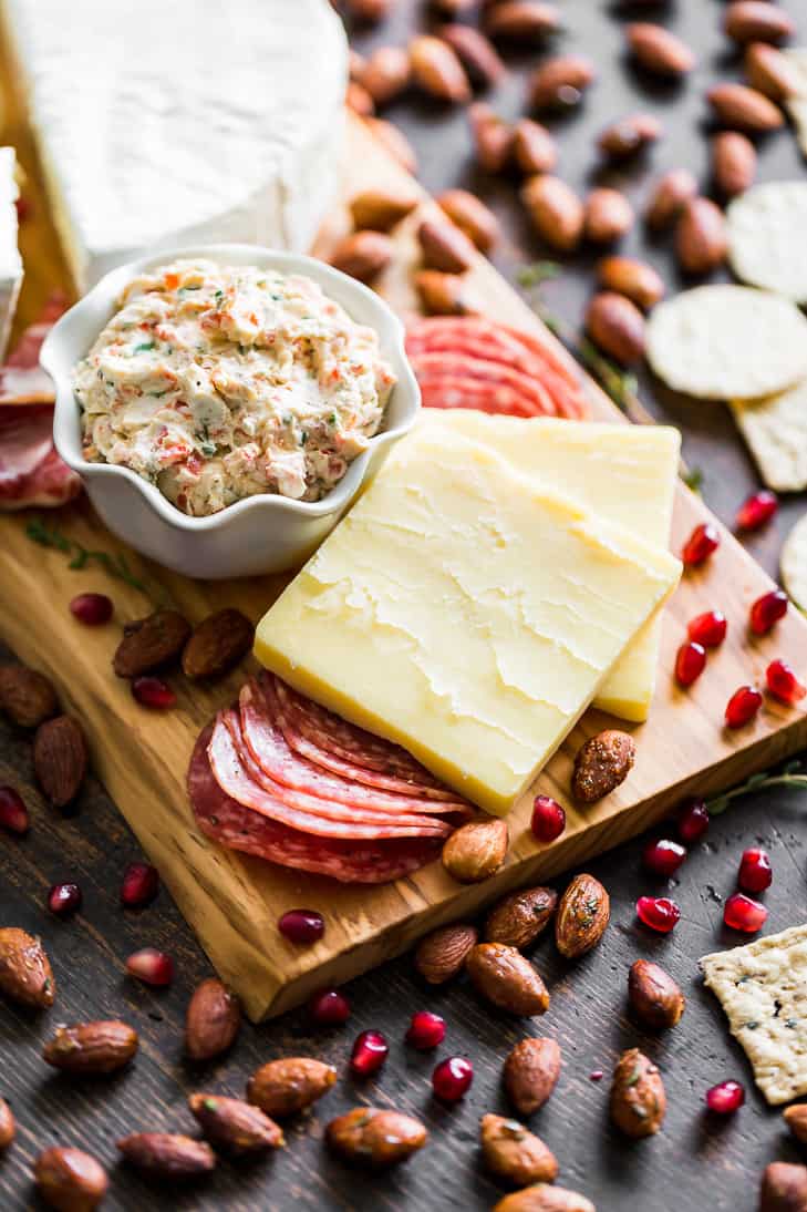 Cheeses and sliced meats piled together on a board for an easy date night idea.