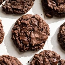 Double chocolate cookies on parchment paper.