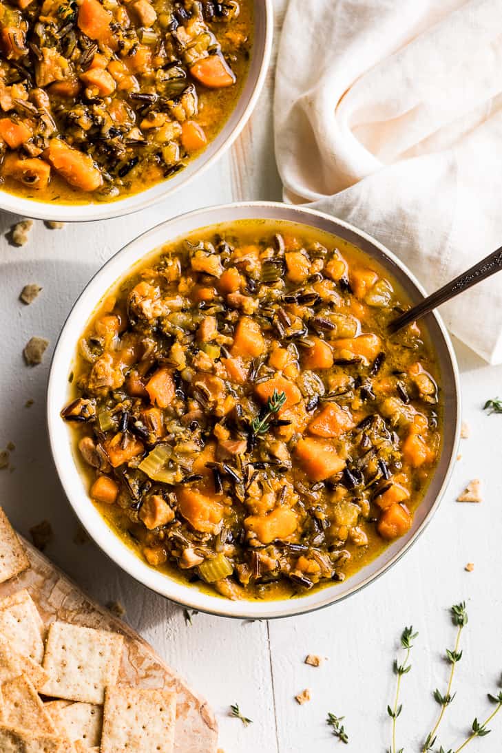 Bowls of Instant Pot Wild Rice Soup with a side of crackers.