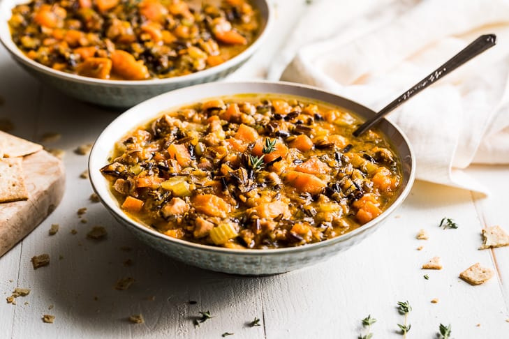 Bowls of Chicken and Wild Rice Soup with Crackers.