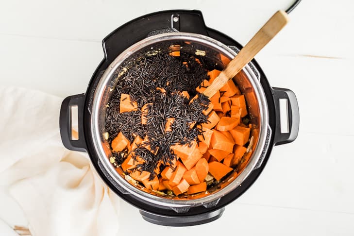 The third step of adding sweet potatoes and wild rice to the instant pot.