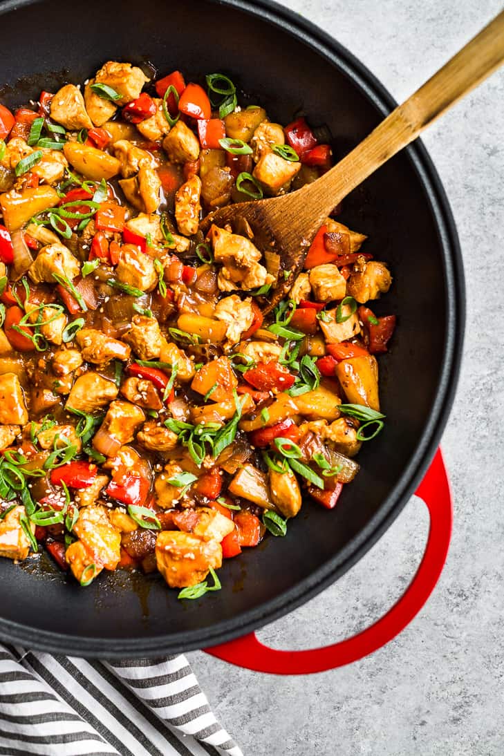 Whole30 Sweet and Sour Chicken Stir Fry in a red frying pan.
