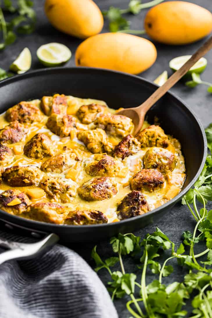 Thai Mango Meatballs with Coconut Sauce in a skillet.