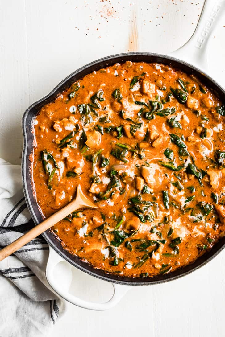 Straight down view of Ethiopian Berbere Chicken Curry in a white skillet.