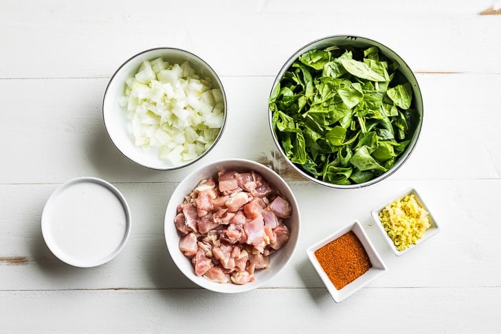 All the ingredients for the Berbere Chicken Curry prepped and placed in bowls.