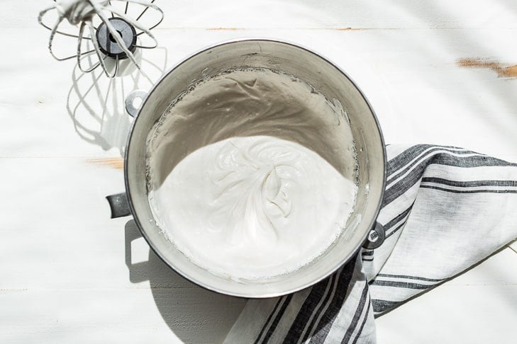 Coconut whipped cream in an electric mixer bowl.