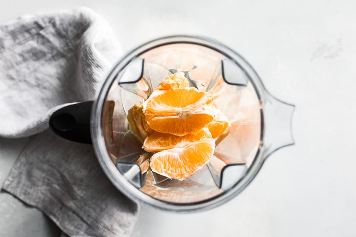 Oranges peeled and in the blender as the first step in making this recipe.