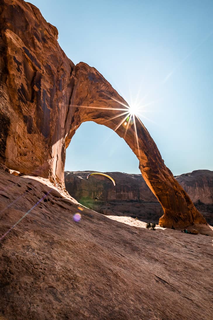 A second man parasailing through the Corona Arch.