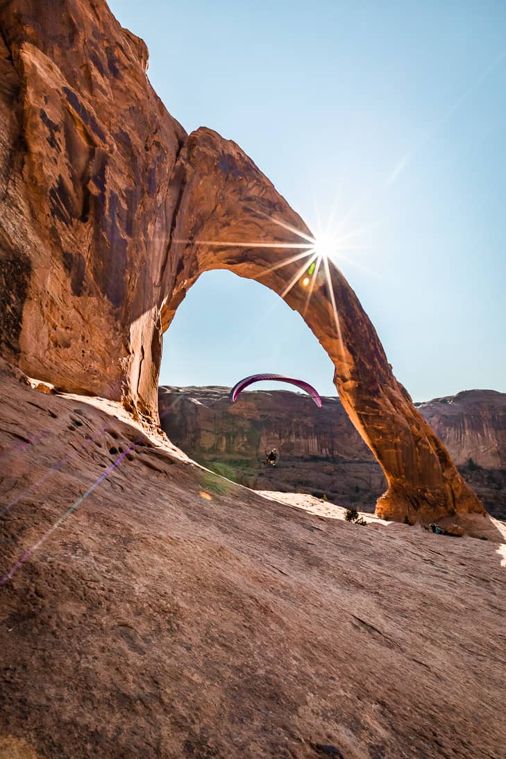 Parasailing through the Corona Arch in Moab.