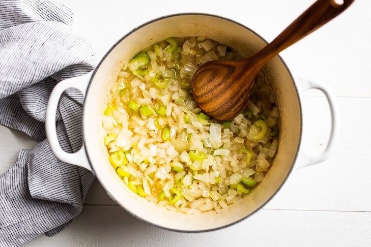 Sautéing the onion, garlic, and celery to begin the clam chowder soup.