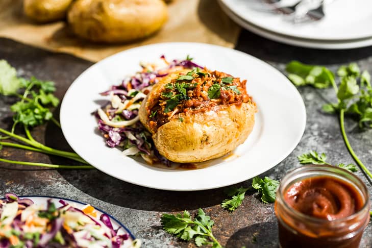 Instant Pot BBQ Chicken in a baked potato with coleslaw as one of the easy dinners in this roundup!