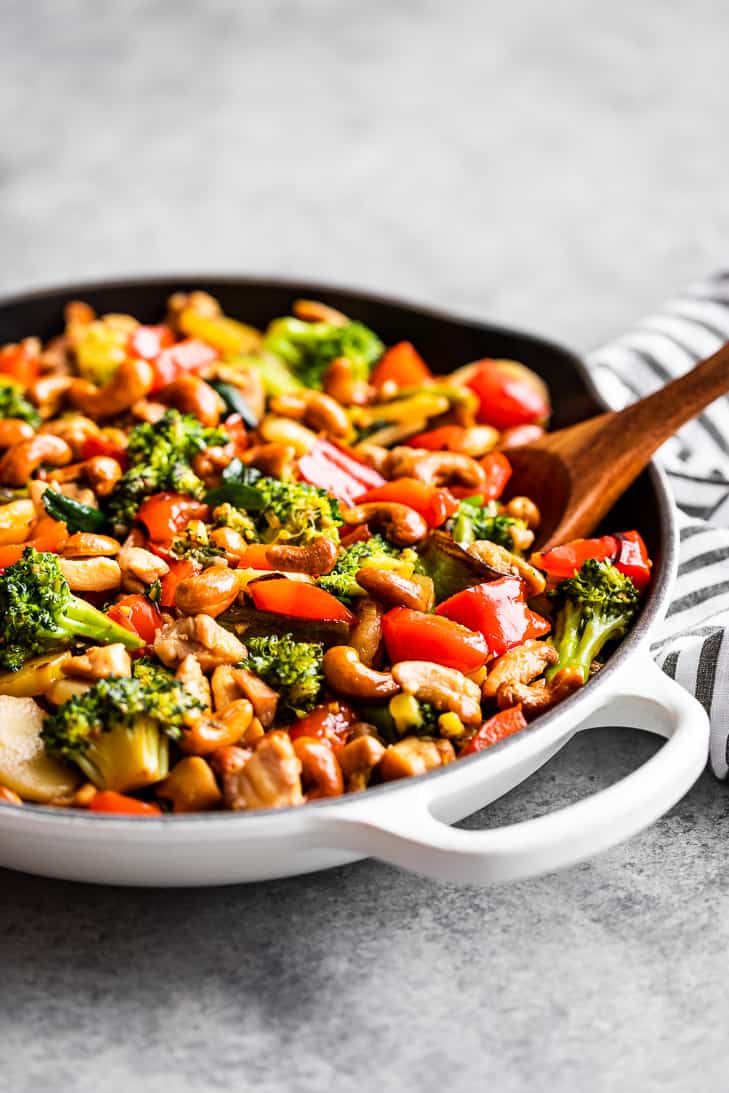 A white skillet full of cashew chicken.