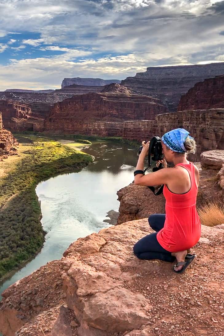 A girl taking a photo at Thelma and Louise Point.