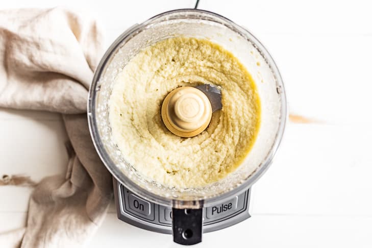 The cooked cauliflower rice being 'mashed' in the food processor.