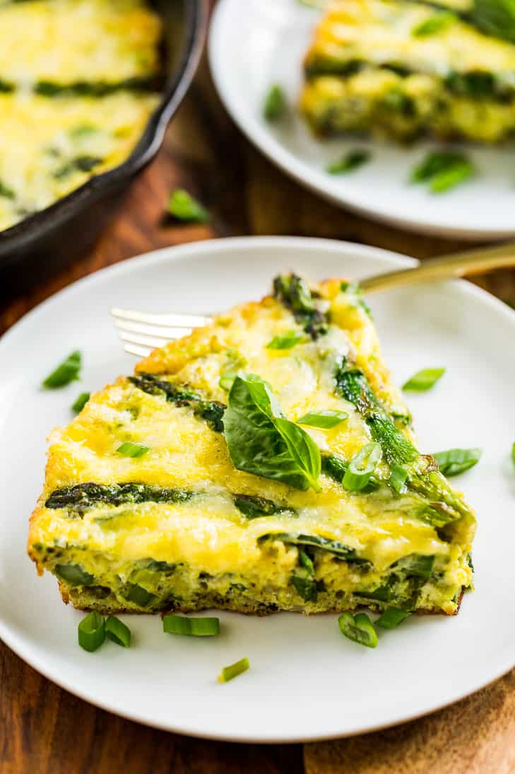 Asparagus Fontina Frittata on a white plate with a gold fork.