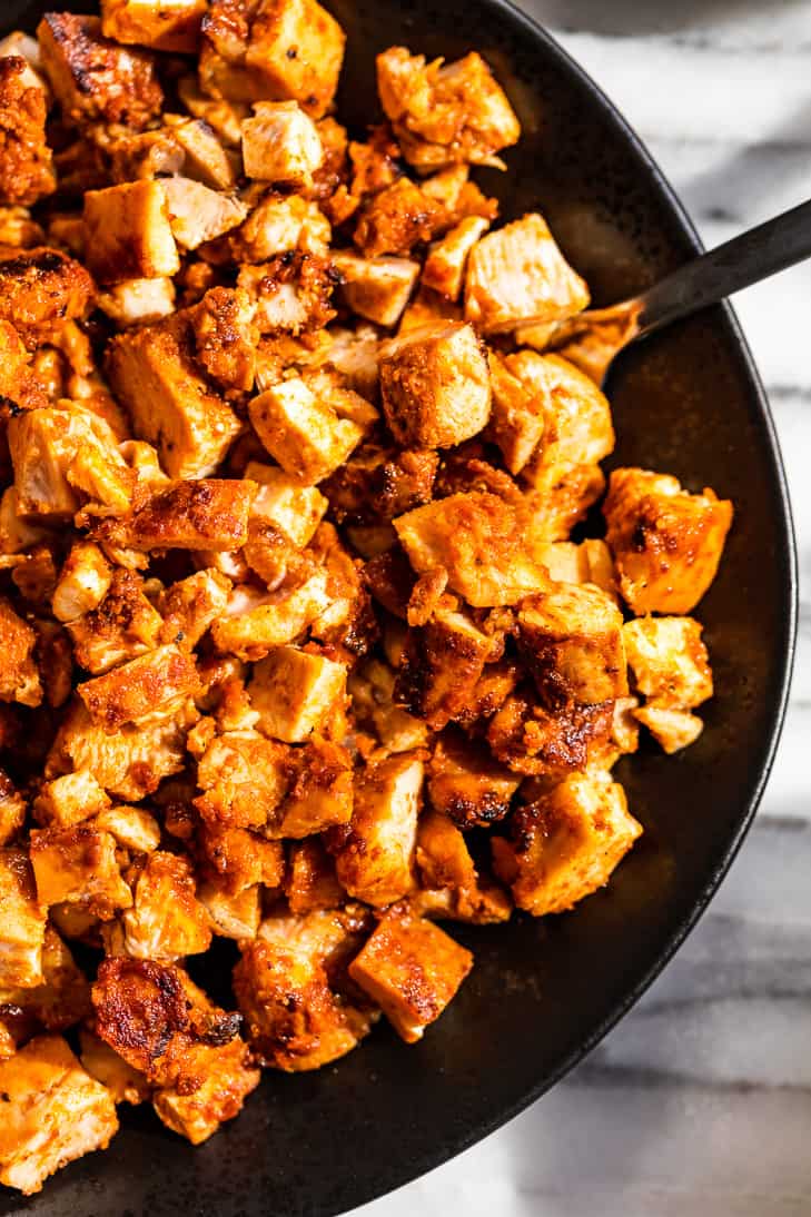 Up close view of Copycat Chipotle Chicken on a black plate.