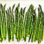 Finished roasted asparagus on parchment paper.