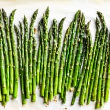 Finished roasted asparagus on parchment paper.