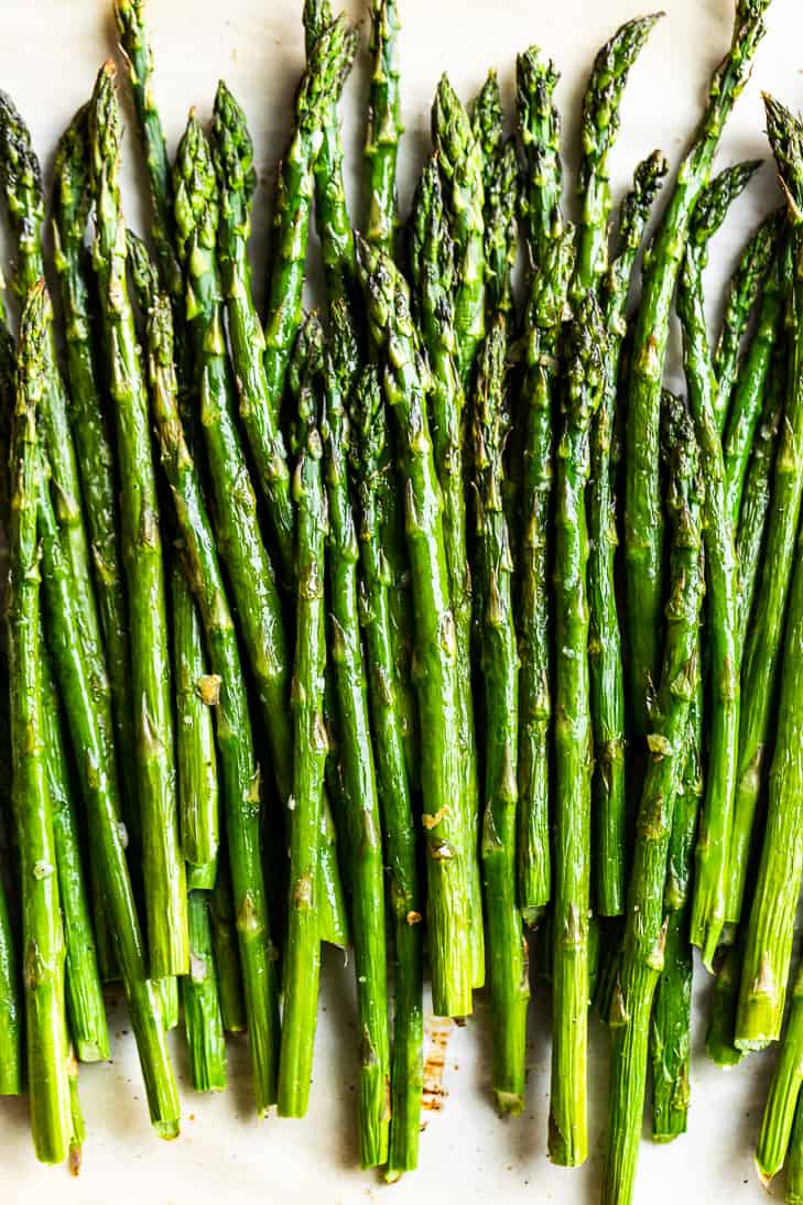 A close up view of Perfect Roasted Asparagus piled together.