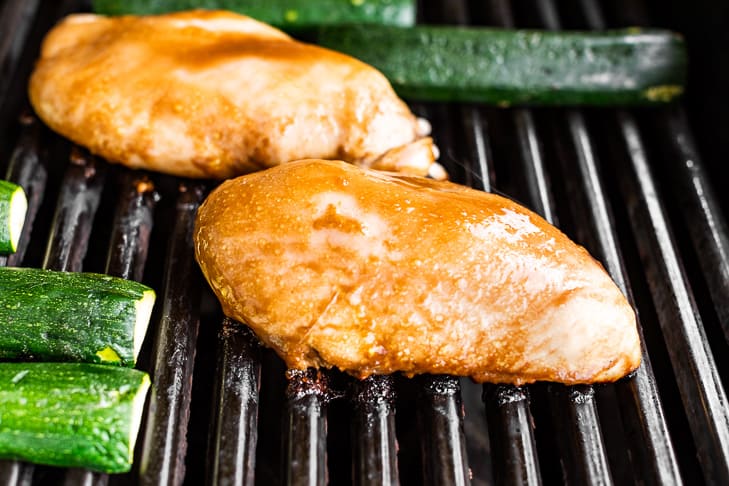 Balsamic marinated chicken on the grill with the zucchini.