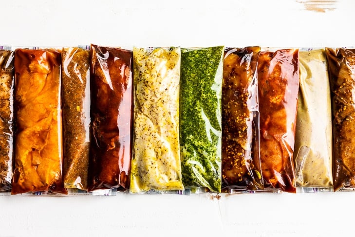 10 Best Chicken Marinades in plastic bags horizontally placed on a white background.
