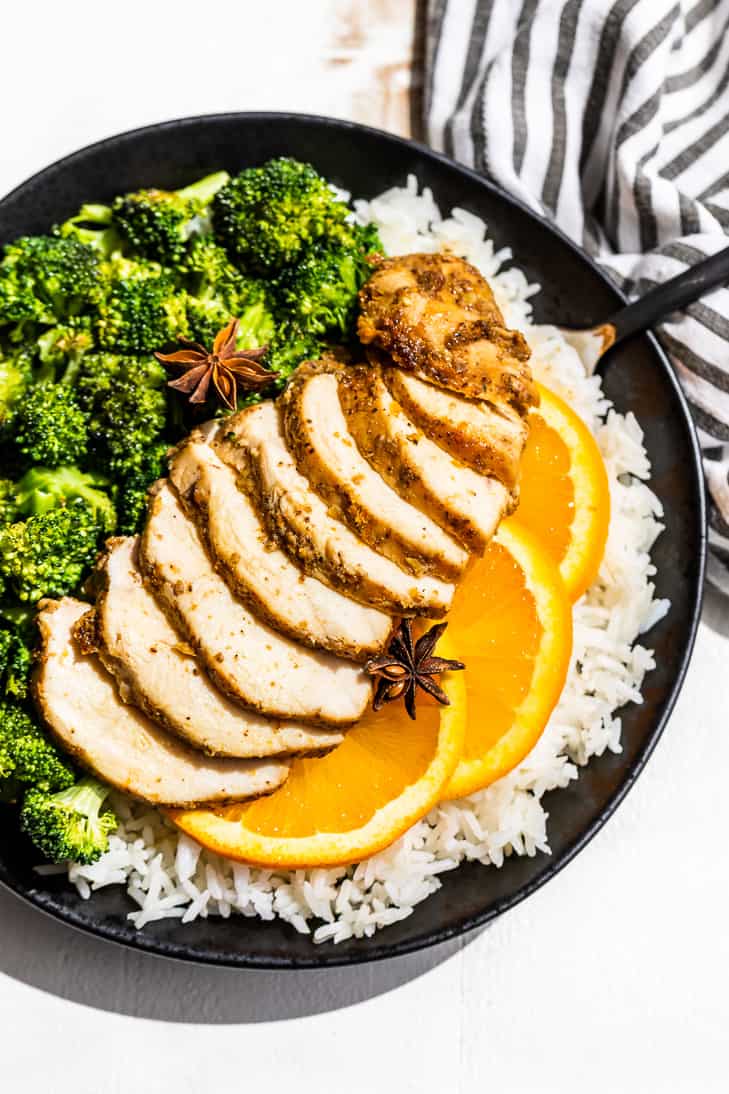 The Orange 5-Spice Marinaded Chicken cooked, sliced and placed over the top of rice with roasted broccoli on the side.