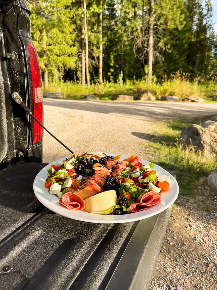 A side view of the Summer Antipasto Platter on a truck tailgate with trees in the background.
