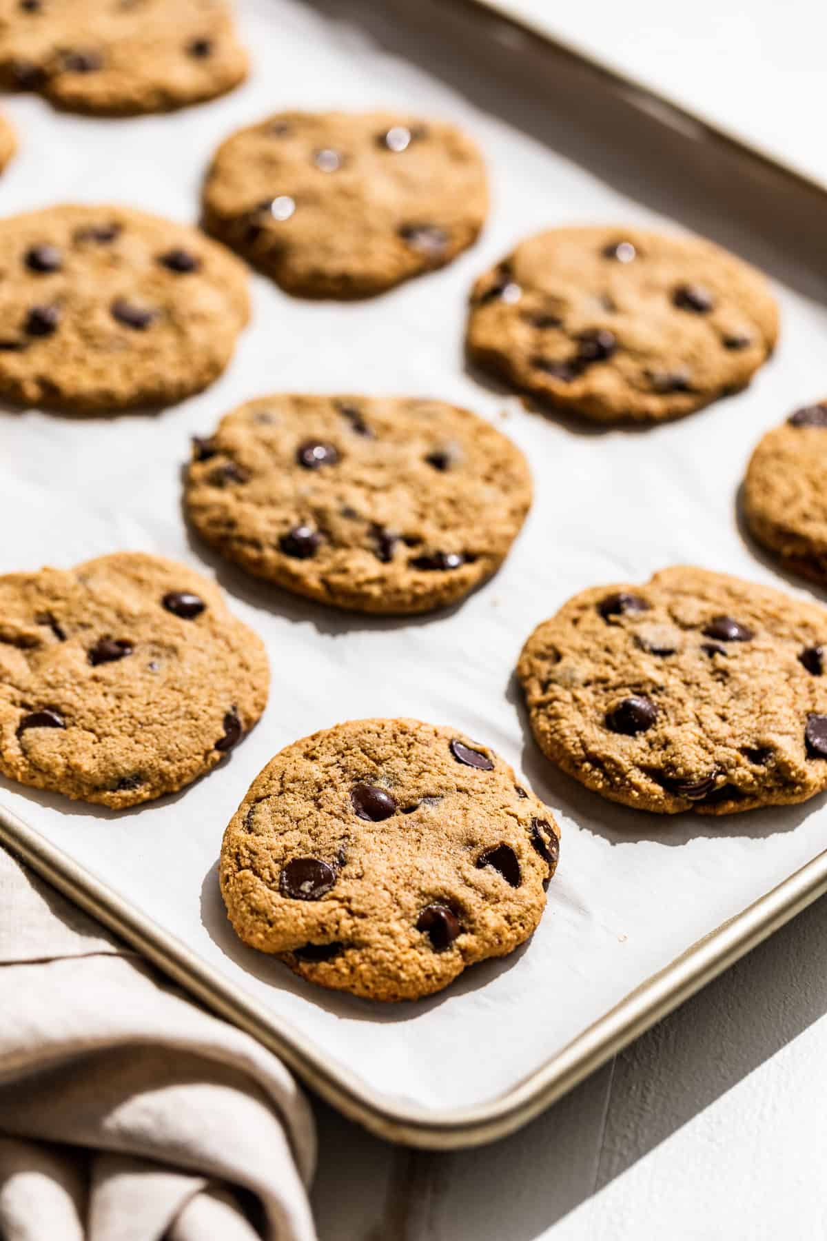 Chocolate Chip Cookies on a parchment lined baking sheet.