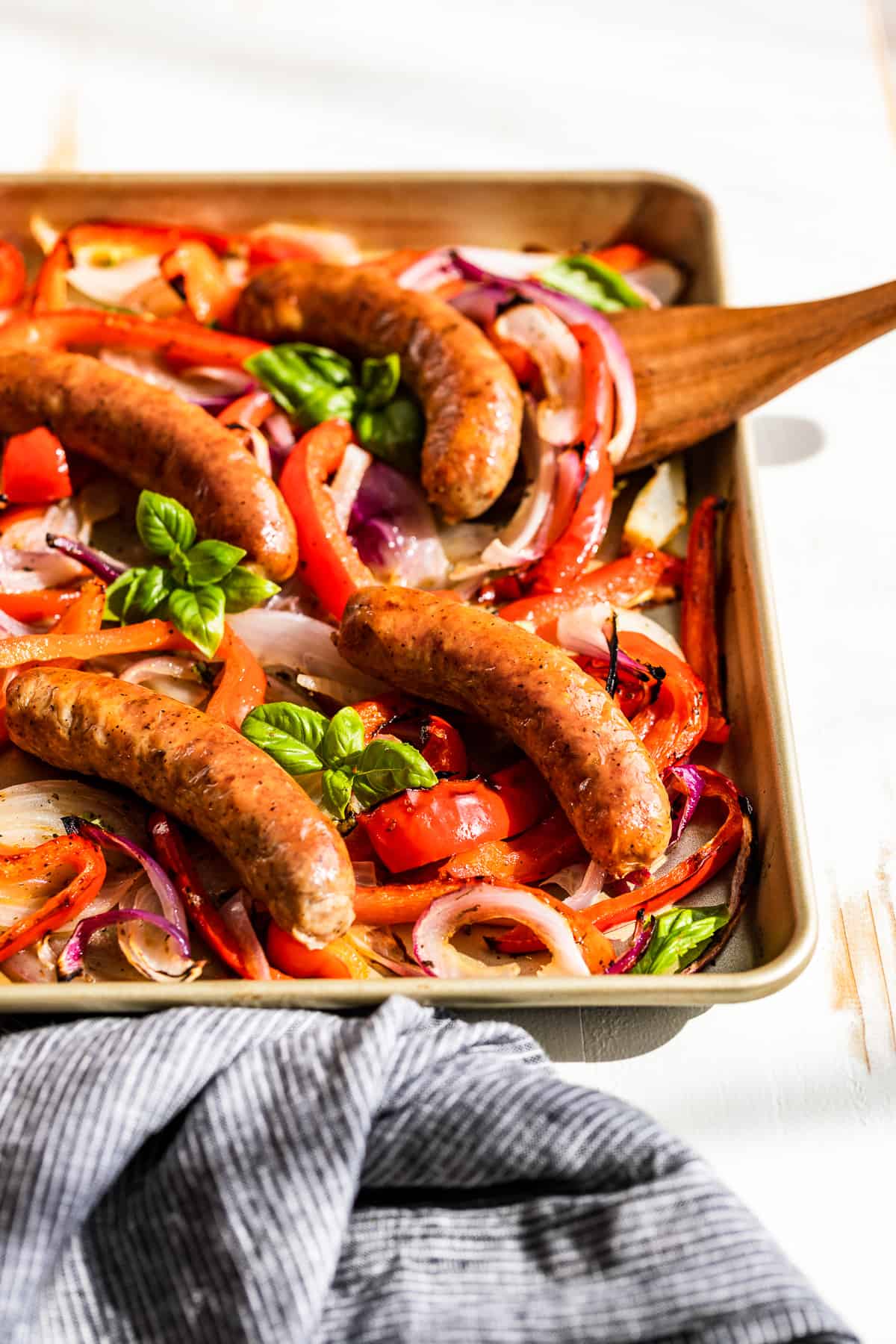 Side view of sausage with peppers and onions.