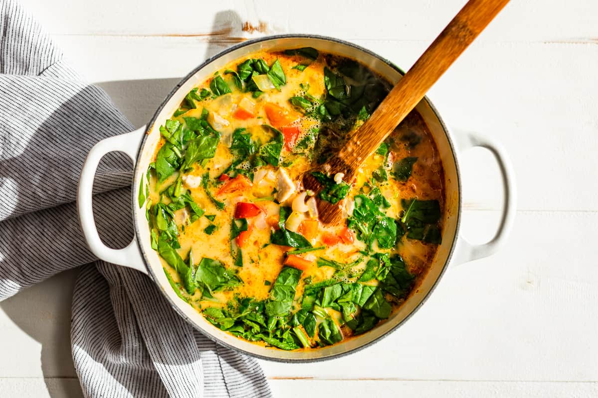 Adding the spinach to the soup.