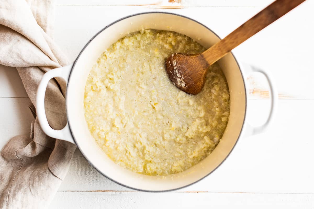 Adding the coconut milk and frozen cauliflower rice to the garlic butter.