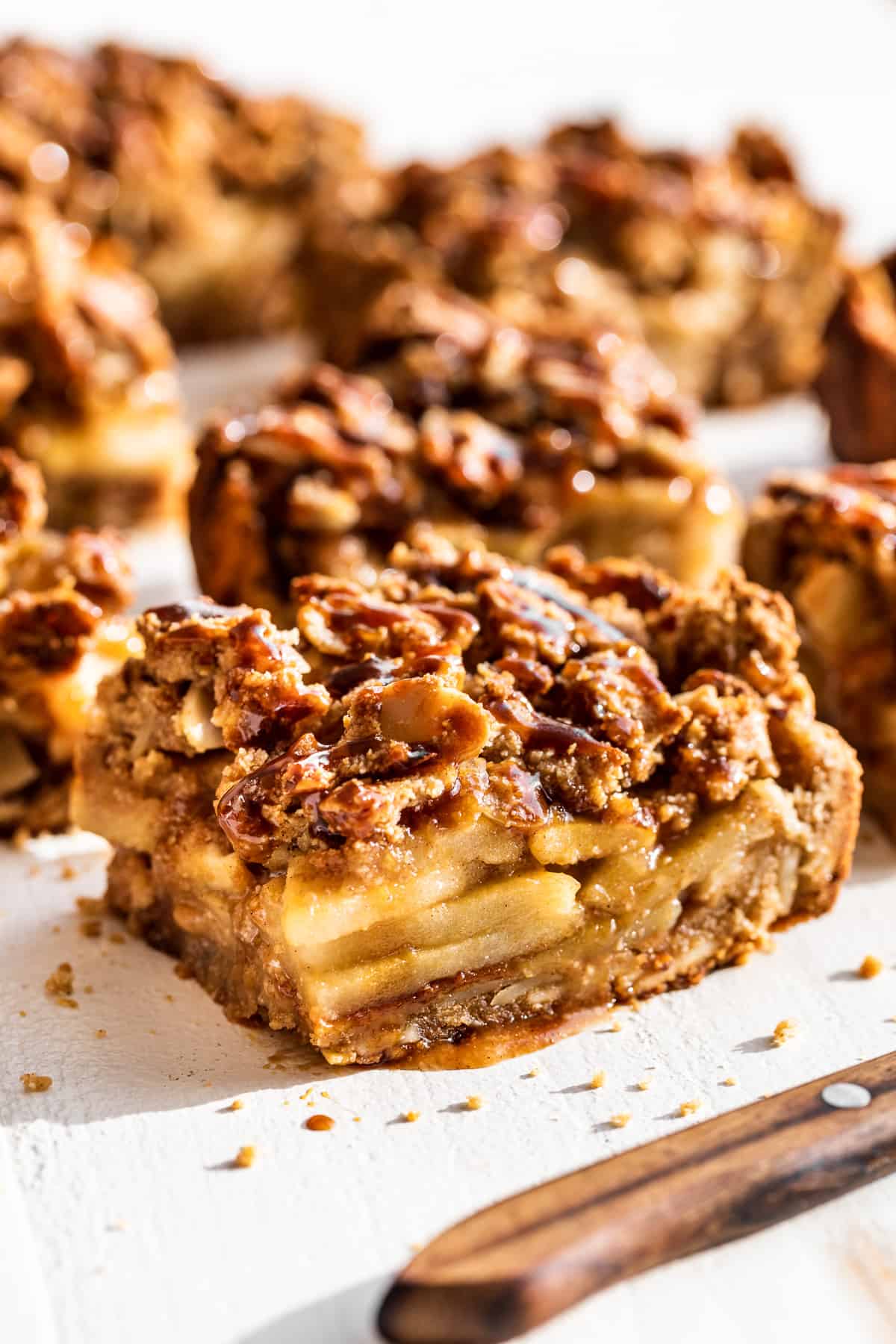 Side view of Apple Pie Bars with caramel sauce on top.