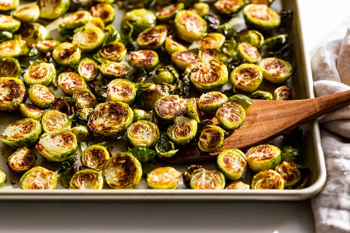 Finished browned Brussels sprouts on a baking sheet.