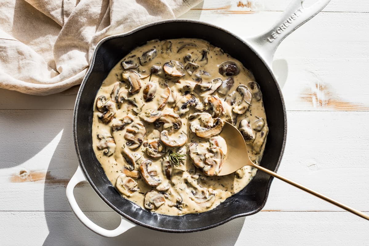 Finished Mushroom Cream Sauce in a white skillet.