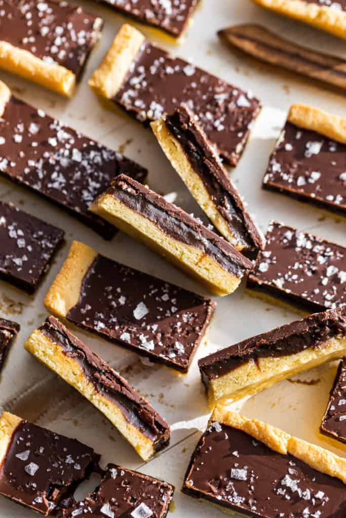 Straight down view of the cut up Twix Bars with some on the side to show the caramel.