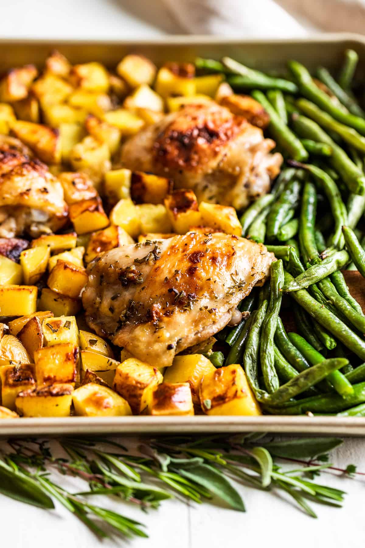 Close up view of Garlic Butter Chicken on a gold sheet pan.