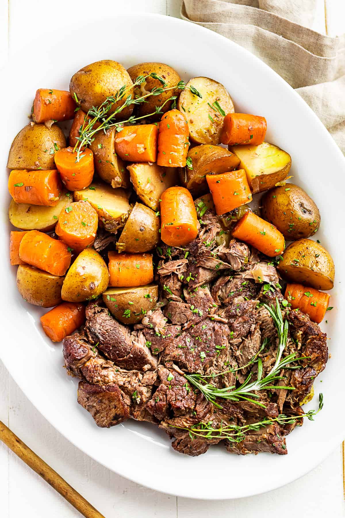 The Slow Cooker Pot Roast arranged on a large white plater.