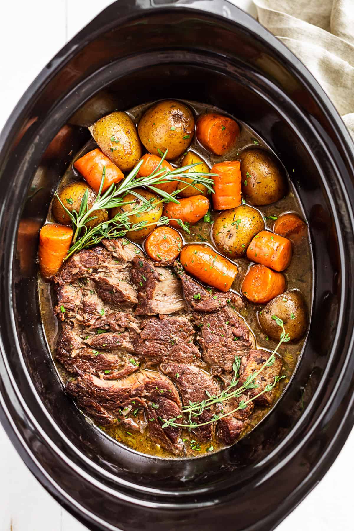 Straight down view of Pot Roast in the slow cooker bowl.