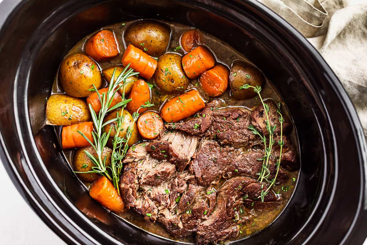 A close side view of the Slow Cooker Pot Roast in the slow cooker bowl.