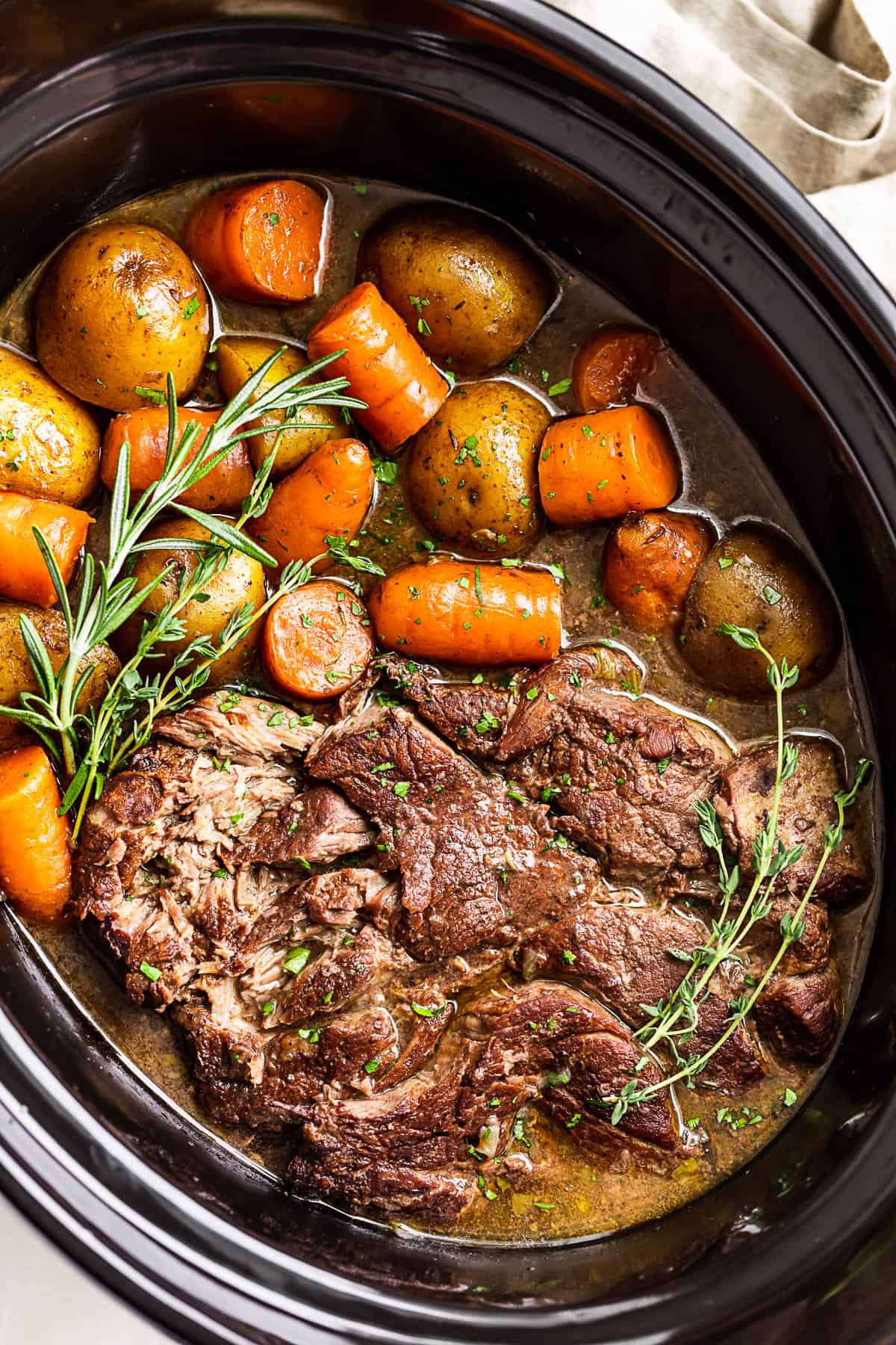 Side view of the Slow Cooker Pot Roast in a slow cooker bowl.