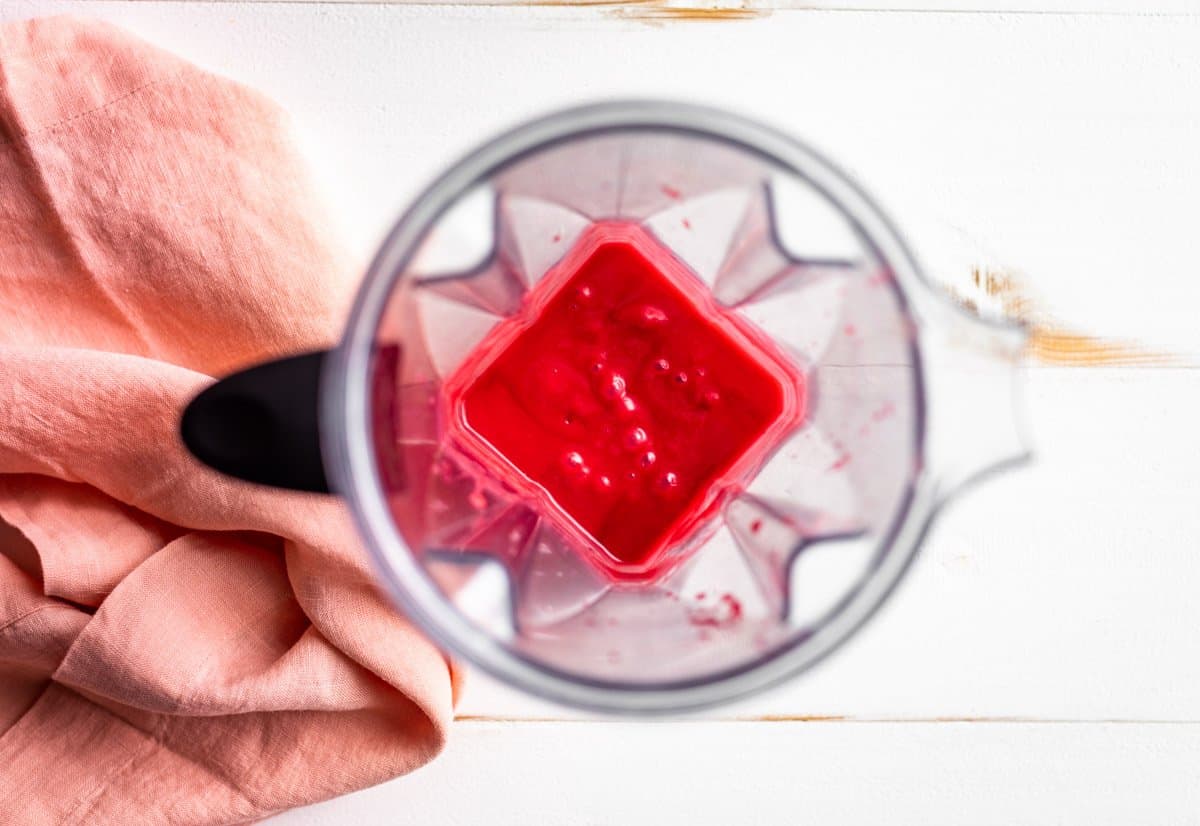 The strained raspberry sauce blended in the blender container.